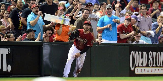 Apr 22, 2015; Phoenix, AZ, USA; Fans react to a sliding catch by Arizona Diamondbacks center fielder Ender Inciarte (5) during the fourth inning against the Texas Rangers at Chase Field. Mandatory Credit: Joe Camporeale-USA TODAY Sports