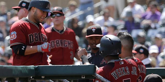 Arizona Diamondbacks' Welington Castillo, left, is congratulated after hitting a home run against the Colorado Rockies during the fourth inning of a spring training baseball game in Scottsdale, Ariz., Thursday, March 31, 2016. (AP Photo/Jeff Chiu)