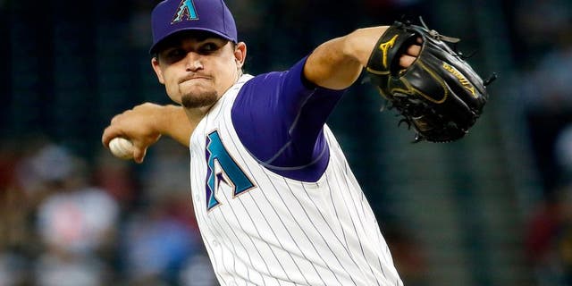 Arizona Diamondbacks pitcher Zack Godley throws during the first inning of a baseball game against the Milwaukee Brewers, Thursday, July 23, 2015, in Phoenix. (AP Photo/Matt York)