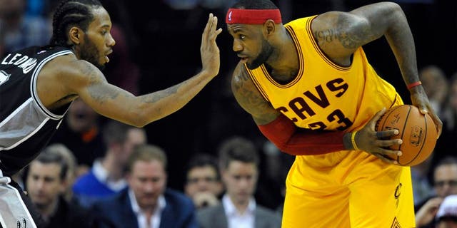 Nov 19, 2014; Cleveland, OH, USA; San Antonio Spurs forward Kawhi Leonard (2) defends Cleveland Cavaliers forward LeBron James (23) in the third quarter at Quicken Loans Arena. Mandatory Credit: David Richard-USA TODAY Sports