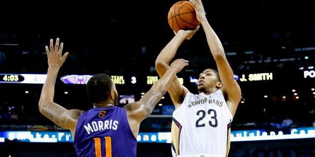 Nov 5, 2013; New Orleans, LA, USA; New Orleans Pelicans power forward Anthony Davis (23) shoots over Phoenix Suns power forward Markieff Morris (11) during the second quarter at New Orleans Arena. Mandatory Credit: Derick E. Hingle-USA TODAY Sports