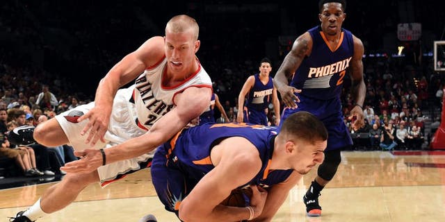 Portland Trail Blazers forward Mason Plumlee dives for the ball with Phoenix Suns center Alex Len during the first quarter of an NBA basketball preseason game in Portland, Ore., Friday, Oct. 7, 2016. (AP Photo/Steve Dykes)