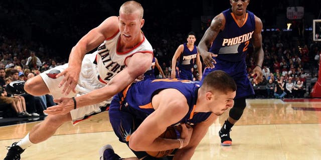 Portland Trail Blazers forward Mason Plumlee dives for the ball with Phoenix Suns center Alex Len during the first quarter of an NBA basketball preseason game in Portland, Ore., Friday, Oct. 7, 2016. (AP Photo/Steve Dykes)