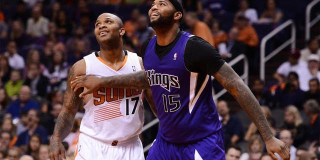Nov 20, 2013; Phoenix, AZ, USA; Sacramento Kings center DeMarcus Cousins (15) boxes out Phoenix Suns forward P.J Tucker (17) at US Airways Center. The Kings defeated the Suns 113-106. Mandatory Credit: Jennifer Stewart-USA TODAY Sports