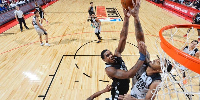 LAS VEGAS, NV - JULY 17: Coty Clarke #44 of the Minnesota Timberwolves shoots the ball against Richard Solomon #32 of the Phoenix Suns during the 2016 NBA Las Vegas Summer League game on July 17, 2016 at the Thomas & Mack Center in Las Vegas, Nevada. NOTE TO USER: User expressly acknowledges and agrees that, by downloading and or using this photograph, User is consenting to the terms and conditions of the Getty Images License Agreement. Mandatory Copyright Notice: Copyright 2016 NBAE (Photo by David Dow/NBAE via Getty Images)