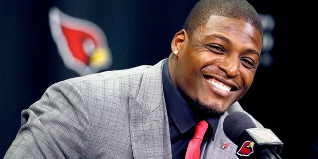 Arizona Cardinals' Adrian Wilson smiles after announcing his retirement, Monday, April 20, 2015, at the Cardinals team facility in Tempe, Ariz. The five-time pro bowler played 12 seasons for the Cardinals. (AP Photo/Matt York)