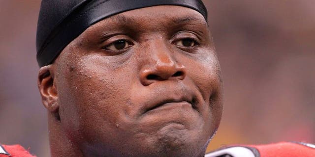 FILE - In this Jan. 16, 2010, file photo, Arizona Cardinals defensive end Bryan Robinson reacts after a New Orleans Saints touchdown during an NFL football divisional playoff game in New Orleans. The Chicago Bears say former defensive lineman Bryan Robinson has died. He was 41. Robinson was found at a Milwaukee motel Saturday night, June 11, 2016. Robinson was with the Bears from 1998 to 2003 and also played for the St. Louis Rams, Miami Dolphins, Cincinnati Bengals and Arizona Cardinals. (AP Photo/Dave Martin, File)