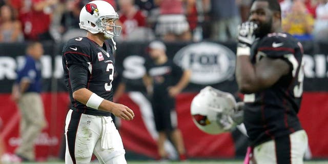 Arizona Cardinals quarterback Carson Palmer (3) walks off the field after an NFL football game against the St. Louis Rams, Sunday, Oct. 4, 2015, in Glendale, Ariz. The Rams won 24-22. (AP Photo/Rick Scuteri)