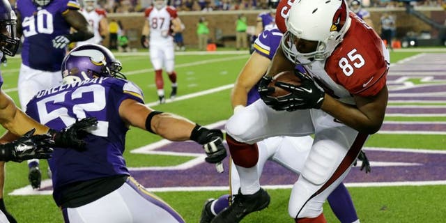 Arizona Cardinals tight end Darren Fells (85) catches a 1-yard touchdown pass in front of Minnesota Vikings outside linebacker Chad Greenway (52) during the first half of an NFL preseason football game, Saturday, Aug. 16, 2014, in Minneapolis. (AP Photo/Ann Heisenfelt)
