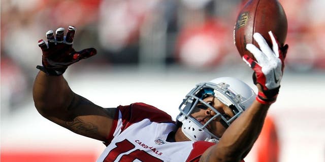 Arizona Cardinals wide receiver Michael Floyd (15) catches a pass against the San Francisco 49ers during the first half of an NFL football game in Santa Clara, Calif., Sunday, Dec. 28, 2014. (AP Photo/Tony Avelar)