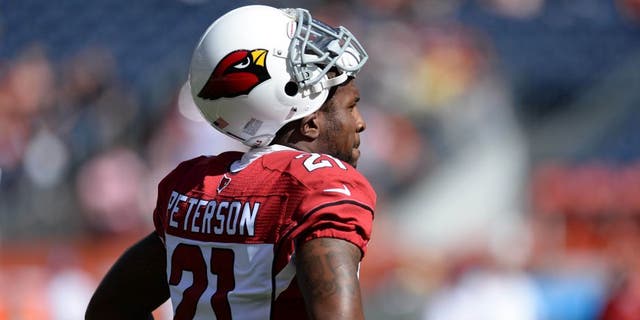Oct 5, 2014; Denver, CO, USA; Arizona Cardinals cornerback Patrick Peterson (21) before the start of the game against the Denver Broncos at Sports Authority Field at Mile High. Mandatory Credit: Ron Chenoy-USA TODAY Sports