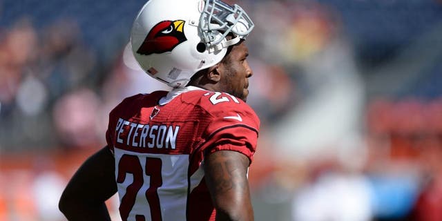 Oct 5, 2014; Denver, CO, USA; Arizona Cardinals cornerback Patrick Peterson (21) before the start of the game against the Denver Broncos at Sports Authority Field at Mile High. Mandatory Credit: Ron Chenoy-USA TODAY Sports