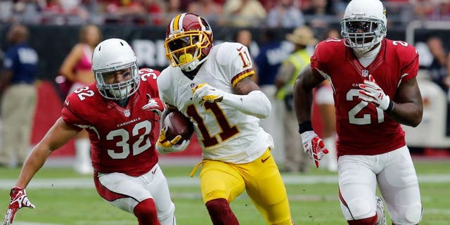 Washington Redskins wide receiver DeSean Jackson (11) runs for a touchdown as Arizona Cardinals free safety Tyrann Mathieu (32) and Patrick Peterson (21) pursue during the first half of an NFL football game, Sunday, Oct. 12, 2014, in Glendale, Ariz.(AP Photo/Rick Scuteri)