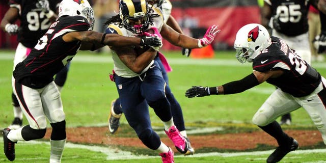 Oct 4, 2015; Glendale, AZ, USA; St. Louis Rams running back Todd Gurley (30) breaks tackles by Arizona Cardinals cornerback Jerraud Powers (25) and free safety Rashad Johnson (26) during the second half at University of Phoenix Stadium. Mandatory Credit: Matt Kartozian-USA TODAY Sports