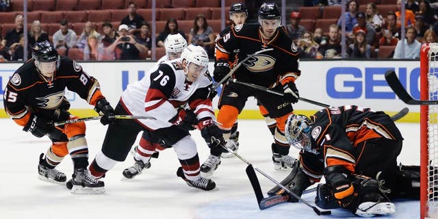 Anaheim Ducks goalie Matthew Hackett, right, stops a shot by Arizona Coyotes' Laurent Dauphin (76) during the first period of an NHL preseason hockey game, Tuesday, Sept. 27, 2016, in Anaheim, Calif. (AP Photo/Jae C. Hong)