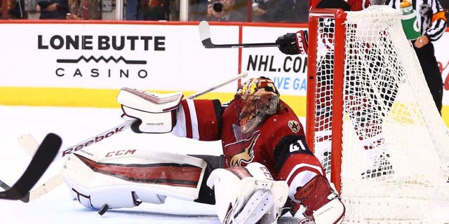 Oct 10, 2015; Glendale, AZ, USA; Arizona Coyotes goalie Mike Smith makes a save in the third period against the Pittsburgh Penguins during the home opener at Gila River Arena. The Coyotes defeated the Penguins 2-1. Mandatory Credit: Mark J. Rebilas-USA TODAY Sports
