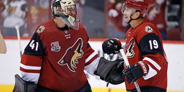 Arizona Coyotes' Mike Smith (41) and Shane Doan (19) celebrate the Coyotes' 3-1 win over the San Jose Sharks in an NHL preseason hockey game Friday, Oct. 7, 2016, in Glendale, Ariz. (AP Photo/Ross D. Franklin)