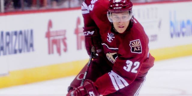 Sep 22, 2014; Glendale, AZ, USA; Arizona Coyotes center Tyler Gaudet (32) carries the puck during the first period against the Los Angeles Kings at Gila River Arena. Mandatory Credit: Matt Kartozian-USA TODAY Sports