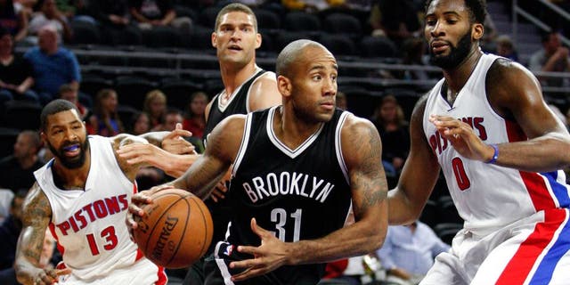 Oct 8, 2015; Auburn Hills, MI, USA; Brooklyn Nets guard Dahntay Jones (31) dribbles the ball past Detroit Pistons center Andre Drummond (0) during the third quarter at The Palace of Auburn Hills. The Nets won 93-83. Mandatory Credit: Raj Mehta-USA TODAY Sports