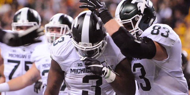 Dec 5, 2015; Indianapolis, IN, USA; Michigan State Spartans running back LJ Scott (3) celebrates the game-winning touchdown with tight end Paul Lang (83) over the Iowa Hawkeyes during the fourth quarter in the Big Ten Conference football championship game at Lucas Oil Stadium. Michigan State won 16-13. Mandatory Credit: Thomas J. Russo-USA TODAY Sports