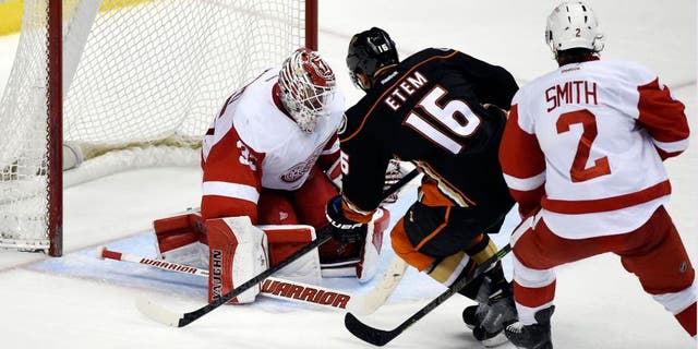 Feb 23, 2015; Anaheim, CA, USA; Anaheim Ducks right wing Emerson Etem (16) scores a goal past Detroit Red Wings goalie Jimmy Howard (35) and defenseman Brendan Smith (2) in the third period during the game at Honda Center. Mandatory Credit: Richard Mackson-USA TODAY Sports