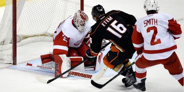Feb 23, 2015; Anaheim, CA, USA; Anaheim Ducks right wing Emerson Etem (16) scores a goal past Detroit Red Wings goalie Jimmy Howard (35) and defenseman Brendan Smith (2) in the third period during the game at Honda Center. Mandatory Credit: Richard Mackson-USA TODAY Sports