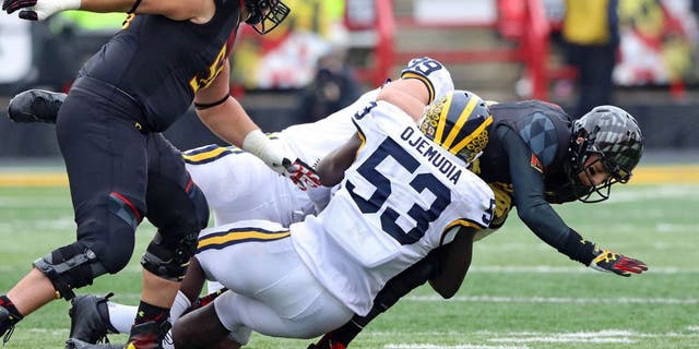 Oct 3, 2015; College Park, MD, USA; Maryland Terrapins quarterback Daxx Garman (18) is sacked by Michigan Wolverines defensive end Mario Ojemudia (53) at Byrd Stadium. Mandatory Credit: Mitch Stringer-USA TODAY Sports