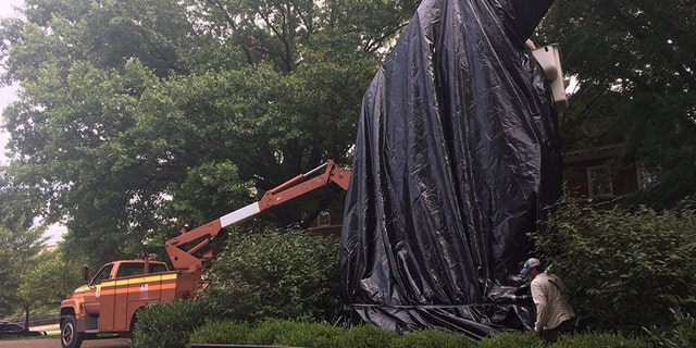 A statue of Confederate Gen. Stonewall Jackson is covered with a black shroud in Charlottesville, Va. Wednesday