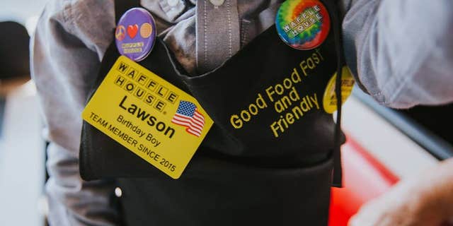 Lawson was given his own name tag and apron with Waffle House pins he was really excited about.