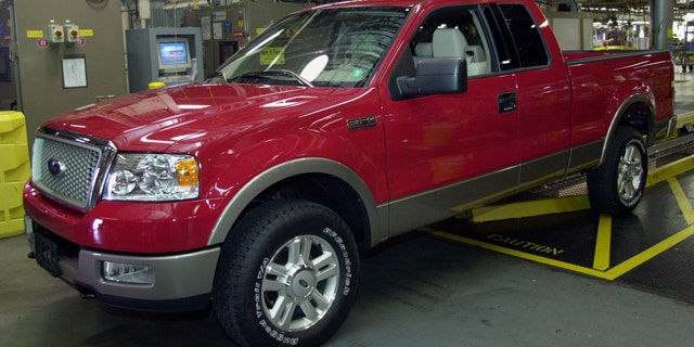 FILE - In this June 10, 2003 file photo, the first of Ford's 2004 F-150 trucks waits to roll off the assembly line at the Norfolk, Va., assembly plant. Ford is recalling more than a million pickups trucks because their gas tanks can fall off and cause fires. The recall involves certain 1997 through 2004 Ford F-150 models, as well as some 1997 through 1999 model year F-250 pickups. Also affected are Lincoln Blackwood pickups from the 2002 and 2003 model years. (AP Photo/Gary C. Knapp, File)