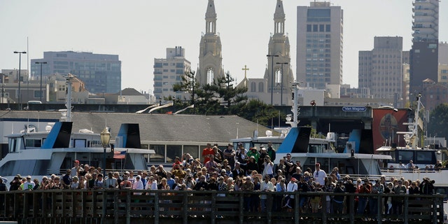 Spectators crowd Pier 39 in San Francisco to watch the 2013 America's Cup sailing event.