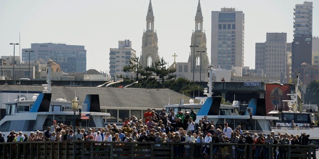 Spectators crowd Pier 39 in San Francisco to watch the 2013 America's Cup sailing event.