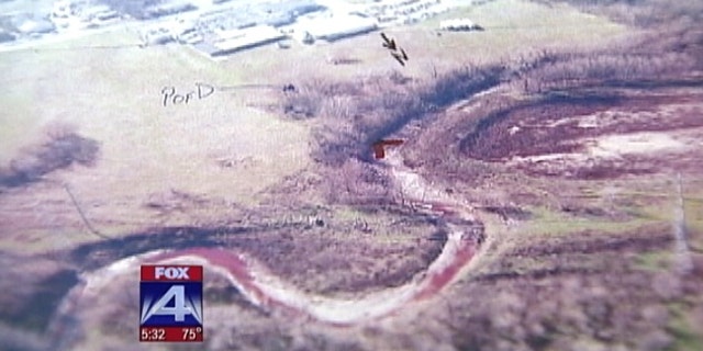 Jan. 20: This aerial photo taken by the Dallas County health department shows what appears to be pig's blood flowing in a creek close to the Columbia Packing company in Dallas.