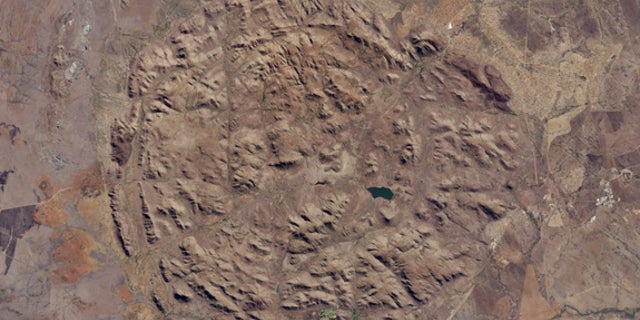 Aerial image of the Pilanesberg National Park in South Africa captured by the Operational Land Imager on Landsat 8 by NASA Earth Observatory.