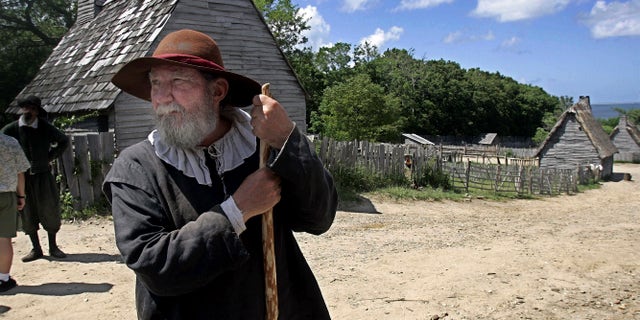FILE - This June 27, 2006, file photo, shows a 17th century costumed role player, who called himself Samuel Fuller, in a 1627 Pilgrim Village at Plimoth Plantation in Plymouth, Mass. Leading scholars from around the globe are teaming up to shed more light on how America got its start. Prominent museums and historical societies from the U.S. and Europe that specialize in the 17th century have formed New England Beginnings. The group said its also trying to dispel myths about how the settlers interacted with Native Americans. (AP Photo/Chitose Suzuki, File)
