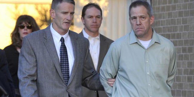 JetBlue pilot Clayton Frederick Osbon, (r.), is escorted by FBI agents after a 2012 incident in which he ran out of the cockpit screaming and terrifying passengers.