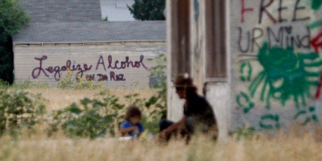 Aug. 13, 2013: Graffiti supporting the legalization of alcohol on the Pine Ridge Indian Reservation is painted on the side of a building in Whiteclay, Neb., indicates support for the legalization of alcohol on the Pine Ridge Indian Reservation,