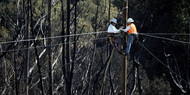 Line workers work to restore power at the site of a gas pipeline explosion in San Bruno, Calif., Monday, Sept. 13, 2010. (AP)