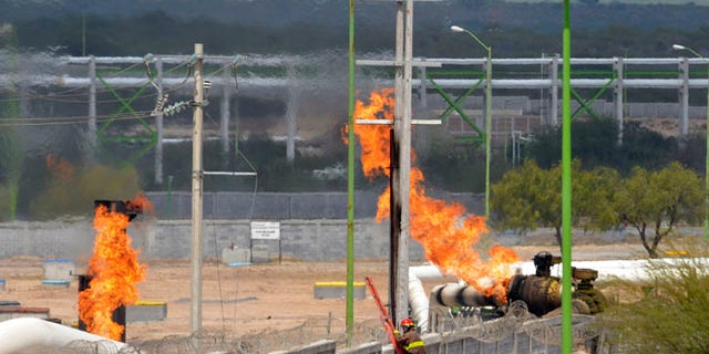 Sept. 18, 2012: Firefighter climb a ladder as they try to control a fire after an explosion at a gas pipeline distribution center in Reynosa, Mexico near Mexico's border with the United States.