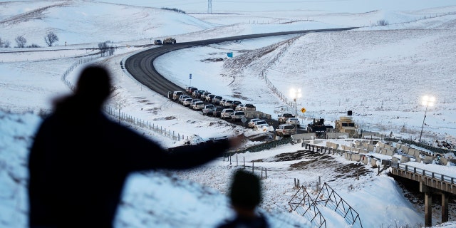 Law enforcement vehicles line a road leading to a blocked bridge next to the Oceti Sakowin camp where people have gathered to protest the Dakota Access oil pipeline in Cannon Ball, N.D., Saturday, Dec. 3, 2016.