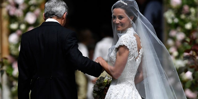 Pippa Middleton is escorted by her father Micheal Middleton as she arrives for her wedding.