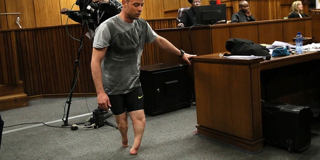 Oscar Pistorius walks on his stumps during argument in mitigation of sentence by his defense attorney Barry Roux in the High Court in Pretoria, South Africa, Wednesday, June 15, 2016. An appeals court found Pistorius guilty of murder and not a lesser charge of culpable homicide for the shooting death of his girlfriend Reeva Steenkamp.  (AP Photo/Alon Skuy, Pool via AP)