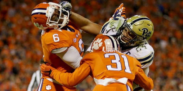 CLEMSON, SC - NOVEMBER 12: Teammates Dorian O'Daniel #6 and Ryan Carter #31 of the Clemson Tigers try to stop James Conner #24 of the Pittsburgh Panthers during their game at Memorial Stadium on November 12, 2016 in Clemson, South Carolina. (Photo by Streeter Lecka/Getty Images)