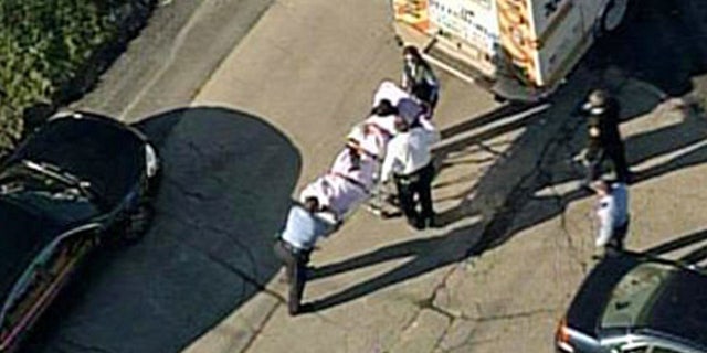 Nov. 13, 2013: In this aerial image provided by KDKA-TV, a person is loaded into an ambulance near Brashear High School in Pittsburgh.