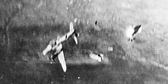 Photo shows "Hell's Fury" after it was hit by enemy flak. The left engine and nacelle are on fire after the left wing was blown off.