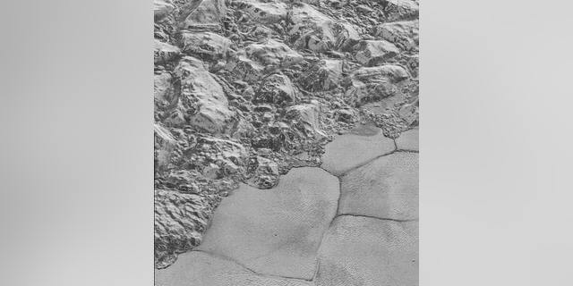 This photo taken by NASA’s New Horizons spacecraft during its July 2015 flyby of Pluto shows the mountain range on the edge of the dwarf planet’s Sputnik Planitia ice plain. Dune formations are clearly visible in the bottom half of the picture.