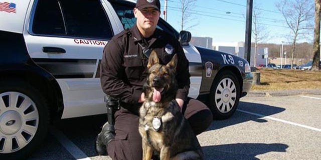 This photo shows police dog Kaiser, a member of Plymouth's K-9 team, pictured with a Plymouth police officer.