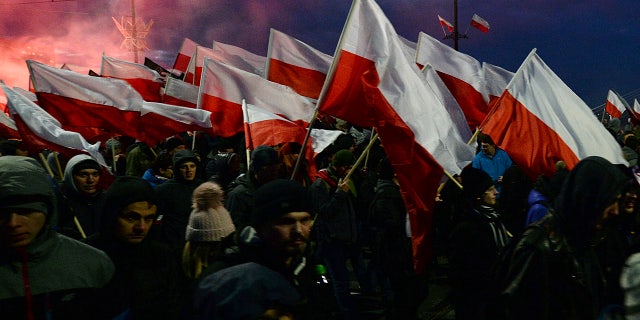 Demonstrators burned flares and waved Polish flags during the march.