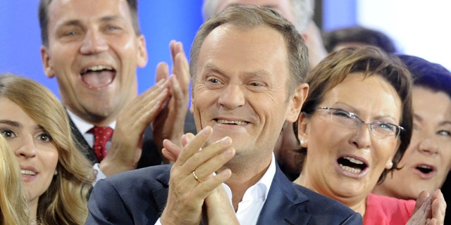 Oct. 9: Prime Minister Donald Tusk, center, celebrates with Health Minister Ewa Kopacz, right, and Foreign Minister Radek Sikorski, background left, as the first exit poll is published during the election party of Tusk's Civic Platform, a centrist and pro-EU party, in Warsaw.