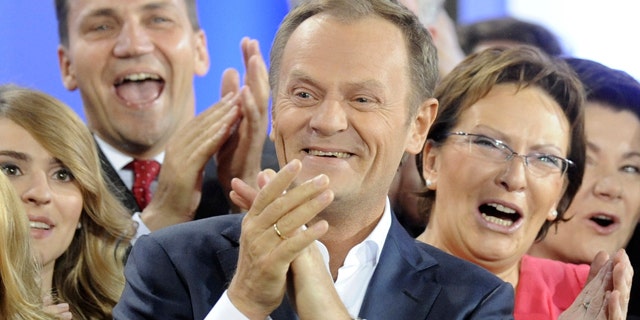 Oct. 9: Prime Minister Donald Tusk, center, celebrates with Health Minister Ewa Kopacz, right, and Foreign Minister Radek Sikorski, background left, as the first exit poll is published during the election party of Tusk's Civic Platform, a centrist and pro-EU party, in Warsaw.